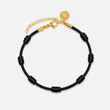 Pulseira Premium dos 7 Nós Preta com Dourado — foto principal